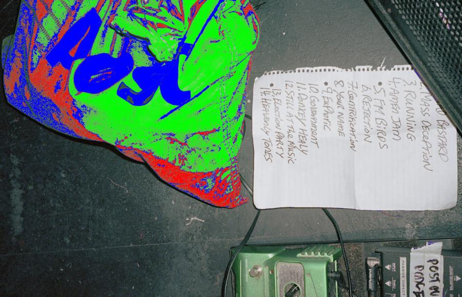 Setlist for Post Punk Podge on floor beside guitar pedal and bag with the An Post Logo.