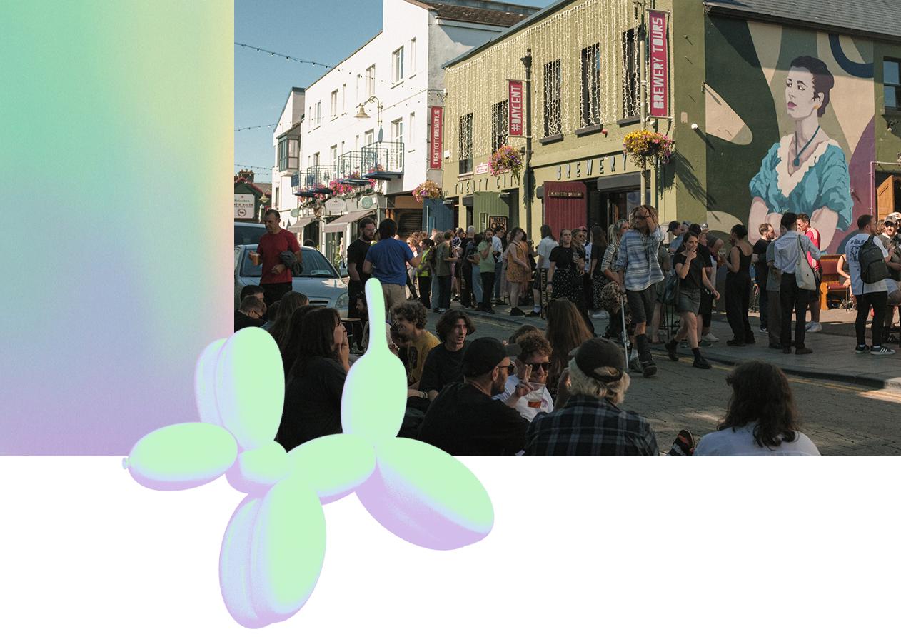 A photo of a busy street outside Treaty City brewery. In front of the image is a 3D holographic balloon dog