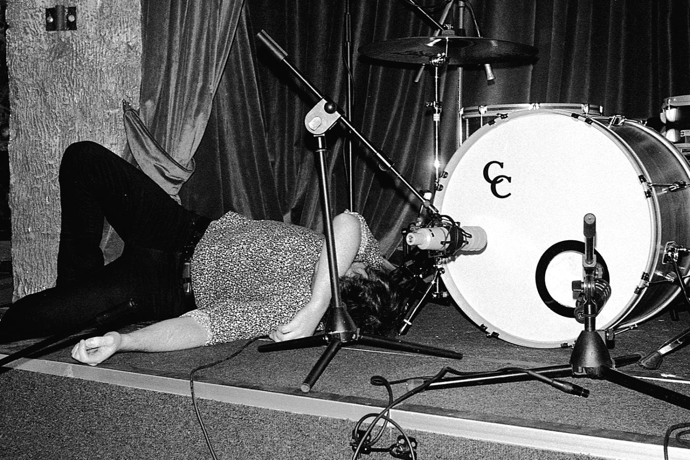 Musician asleep beside a drumkit